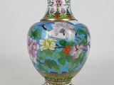 a vase with a bird and flowers painted on it