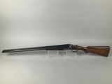 a shotgun with a wooden barrel and a wooden handle