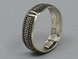 a close up of a silver ring on a gray surface