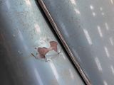 a close up of a car with a rusted paint job on it