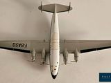 a model of an airplane that is flying in the sky
