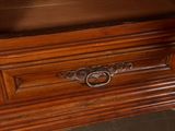 a wooden cabinet with a glass door on top of it