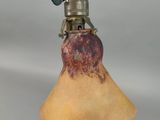 an old fashioned lamp with a glass shade on top of it