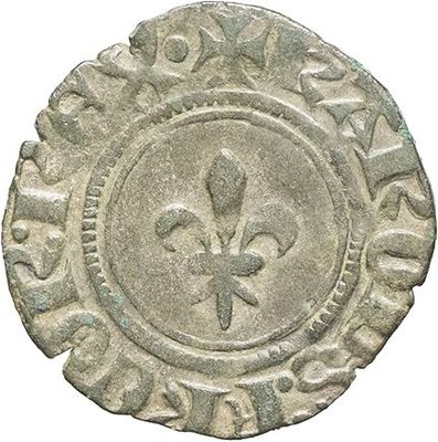 a silver coin with a fleur on the front of it