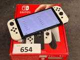 Quelqu'un tient une manette de Nintendo Wii devant une boîte.