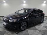 the black car is parked on a checkered floor in the garage