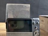a camera that is sitting on a table next to a box