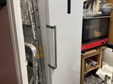 a refrigerator that is in the middle of a room