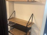 a shelf with a laptop on it in a room