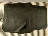 a close up of a pair of black car mats on top of a blanket