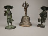 three bronze figurines of asian men with hats and umbrellas