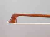 a close up of a violin bow on a white stick