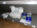many boxes of toilet paper on a shelf in a store