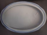a white plate with a blue rim sitting on a table