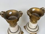 two vases sitting on top of each other on a table