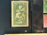 three different colored stamps are on display in a glass case