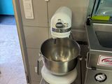 a mixer and a bowl on the counter in the kitchen