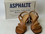 an image of a pair of brown sandals on a white surface