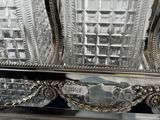 a silver tray with three glass decanters on it