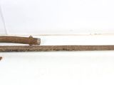 an old rusted metal pipe cutter on a white surface