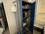 a blue cabinet in the corner of a room