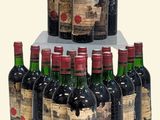 many bottles of wine that are stacked on top of each other