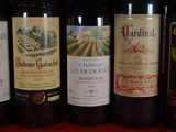 several bottles of wine are lined up on a table