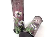 two vases with flowers painted on them on a white surface
