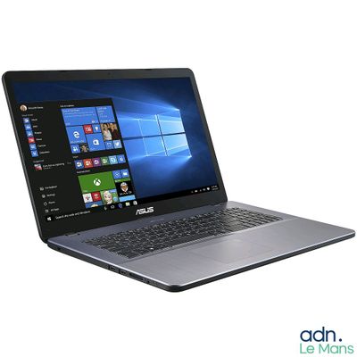 L'ordinateur portable ASUS est ouvert sur une surface blanche, avec Windows affiché à l'écran.