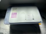 a hp printer sitting on top of a desk next to a mouse