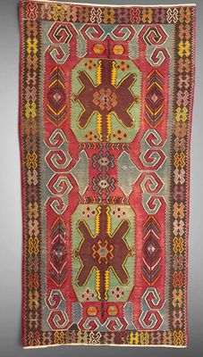 a red and green rug with geometric designs on it