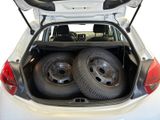 two tires in the back of a car with the trunk open