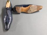 pair of men ' s blue leather shoes on a gray surface