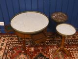 two tables and two stools sitting on a rug in a room