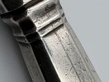 a close up of a silver spoon on a table
