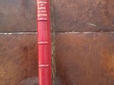 a red book sitting on top of a wooden table