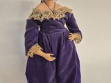 an image of a figurine of a woman in a purple dress