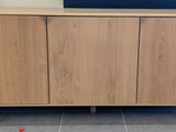 a wooden cabinet with a laptop on top of it