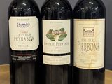 three bottles of wine sitting on a table next to each other
