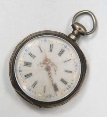 a close up of a pocket watch on a white surface