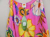 a pink dress with colorful flowers on it hanging on a hanger