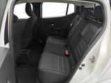 the back seats of a white car with a black seat belt