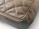 an image of a close up of a brown quilted bag
