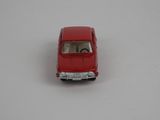 a red toy car sitting on a white surface