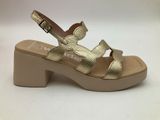 a close up of a pair of gold sandals on a white background