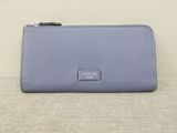 a small blue purse sitting on top of a couch