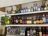 many bottles of alcohol on the shelves in the store