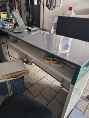 a desk with a laptop and a water bottle on it