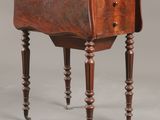 a small wooden table with a drawer on one leg and a drawer on the other