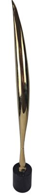gold metal sculpture of a large cone on a black base